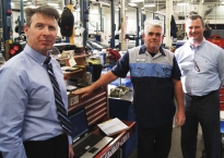 Jim Meehan, center right , at Hopkins Honda was honored by Kevin Barlow, left, American Honda District Parts and Service Manager and GM Kyle Allison.